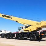 Demag crane lifting heavy equipment at construction site in Australia
